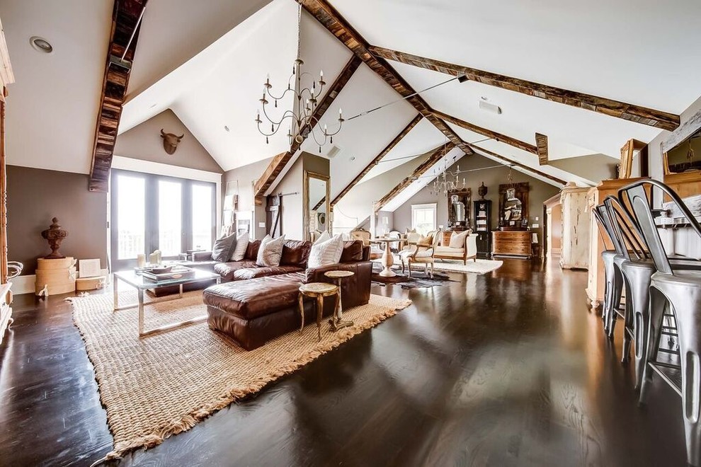 Photo of an expansive country open concept living room in Nashville with brown walls and dark hardwood floors.