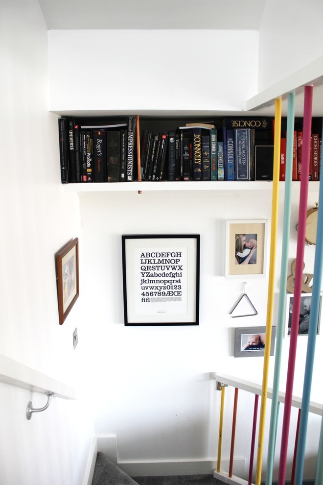 Inspiration for a mid-sized eclectic hallway in Other with white walls and carpet.