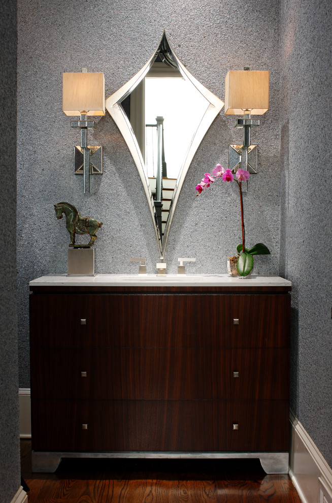 Photo of a mid-sized contemporary powder room in Atlanta with flat-panel cabinets, dark wood cabinets, grey walls, medium hardwood floors, an undermount sink and marble benchtops.