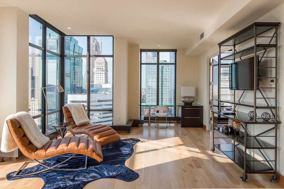 Inspiration for a mid-sized contemporary enclosed light wood floor living room remodel in Minneapolis with beige walls and a wall-mounted tv