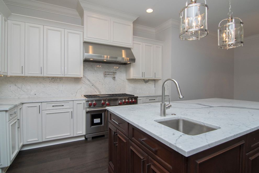 Inspiration for a large transitional u-shaped dark wood floor and brown floor enclosed kitchen remodel in Tampa with an undermount sink, recessed-panel cabinets, white cabinets, marble countertops, gray backsplash, marble backsplash, stainless steel appliances and an island