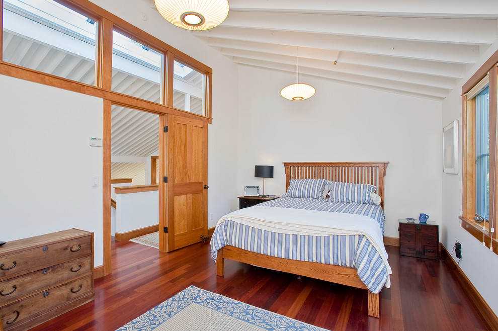 This is an example of a mid-sized contemporary guest bedroom in San Francisco with white walls and medium hardwood floors.