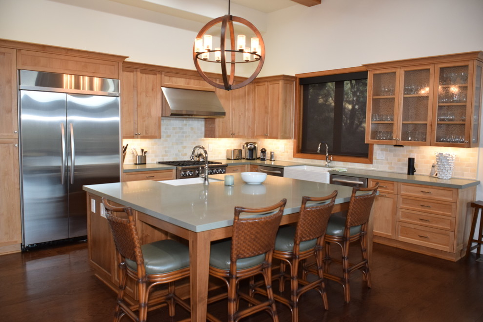Arts and crafts l-shaped eat-in kitchen in Los Angeles with a farmhouse sink, glass-front cabinets, light wood cabinets, quartz benchtops, multi-coloured splashback, stone tile splashback, stainless steel appliances, medium hardwood floors and with island.