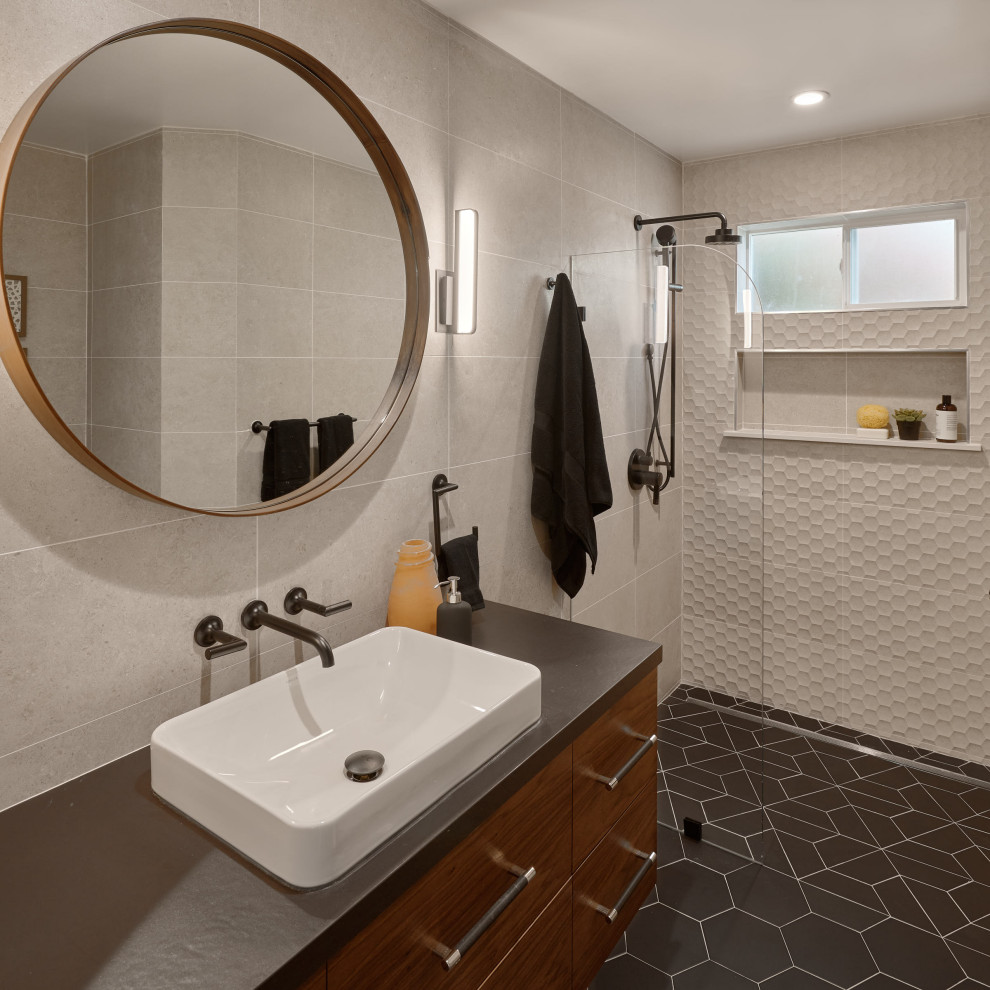 This is an example of a mid-sized modern 3/4 bathroom in San Francisco with flat-panel cabinets, dark wood cabinets, a curbless shower, a one-piece toilet, beige tile, porcelain tile, beige walls, porcelain floors, a vessel sink, solid surface benchtops, black floor, an open shower, black benchtops, a niche, a single vanity and a floating vanity.