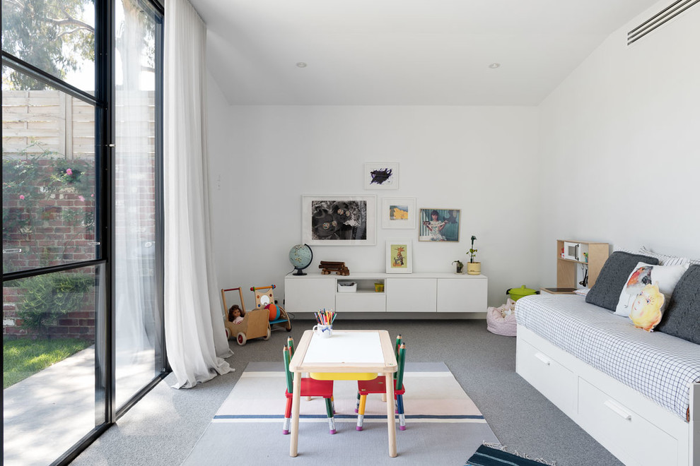 Mid-sized contemporary gender-neutral kids' playroom in Melbourne with white walls, carpet and grey floor for kids 4-10 years old.