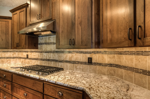 Example of an u-shaped open concept kitchen design in Portland with medium tone wood cabinets, granite countertops, beige backsplash, stainless steel appliances, beige countertops and shaker cabinets