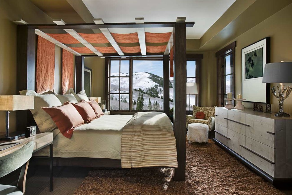 This is an example of a large midcentury master bedroom in Denver with brown walls, carpet and no fireplace.