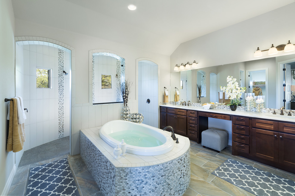 Photo of an expansive traditional master bathroom in Austin with shaker cabinets, dark wood cabinets, a drop-in tub, an open shower, gray tile, mosaic tile, white walls and an open shower.