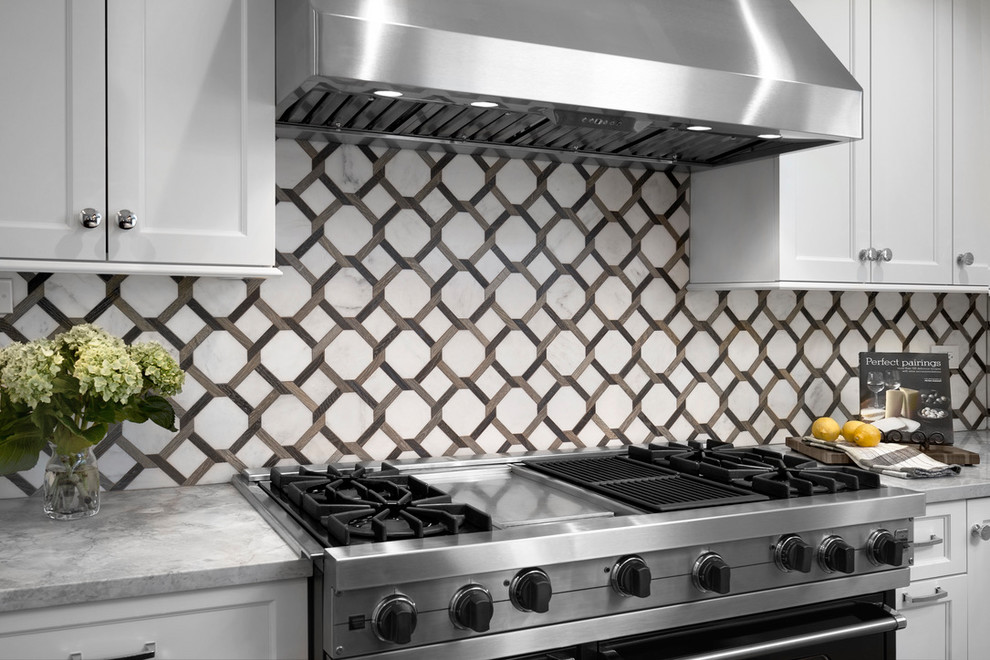Example of a large transitional l-shaped dark wood floor and brown floor open concept kitchen design in Chicago with an undermount sink, recessed-panel cabinets, white cabinets, quartzite countertops, white backsplash, marble backsplash, stainless steel appliances, an island and gray countertops