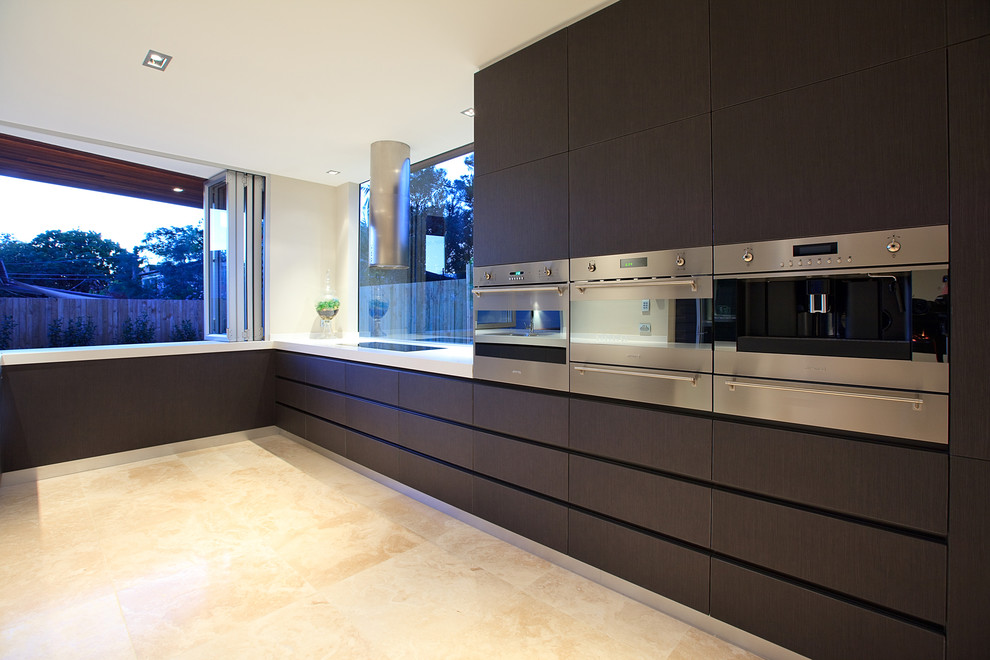 Inspiration for a mid-sized contemporary u-shaped eat-in kitchen in Brisbane with flat-panel cabinets, dark wood cabinets, granite benchtops, window splashback, stainless steel appliances, limestone floors and no island.