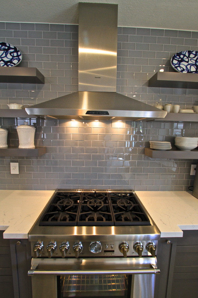 Transitional porcelain tile kitchen photo in Orange County with glass tile backsplash and an island