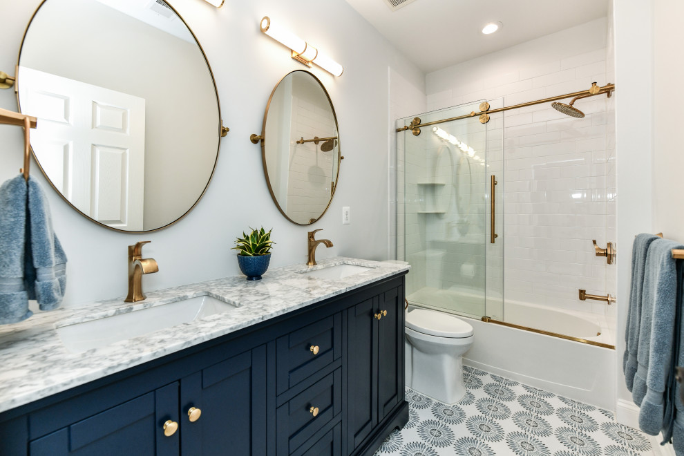 Example of a mid-sized transitional kids' white tile and ceramic tile ceramic tile, blue floor and double-sink bathroom design in DC Metro with shaker cabinets, blue cabinets, a two-piece toilet, blue walls, an undermount sink, marble countertops, gray countertops and a freestanding vanity