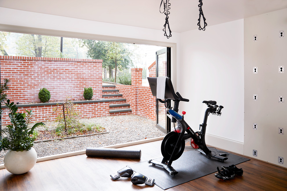 Design ideas for a transitional home gym in Other with white walls, dark hardwood floors and brown floor.