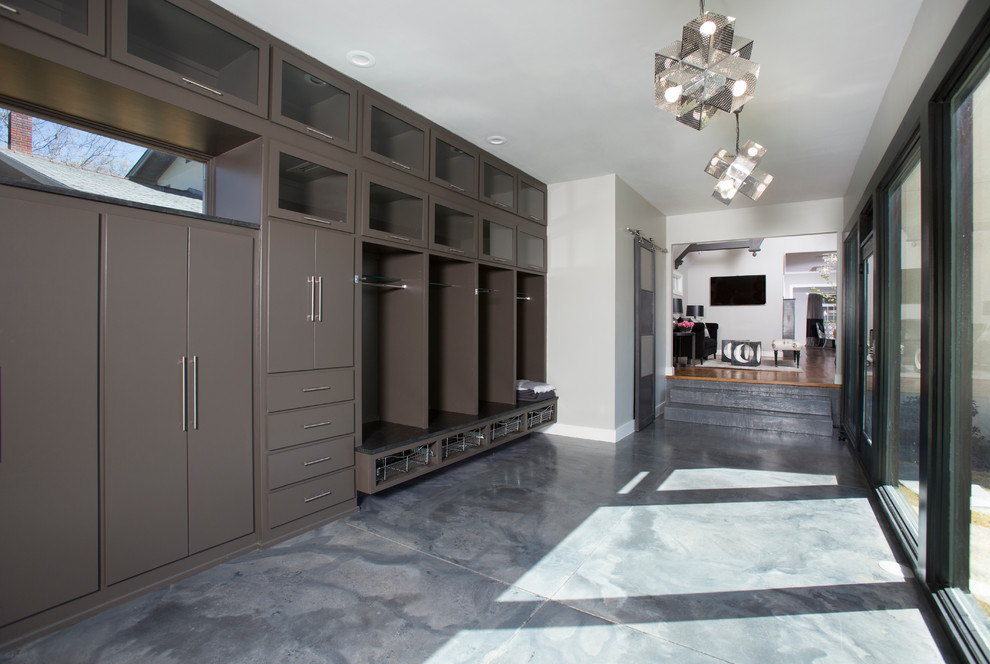 Photo of a mid-sized contemporary hallway in Other with grey walls and concrete floors.