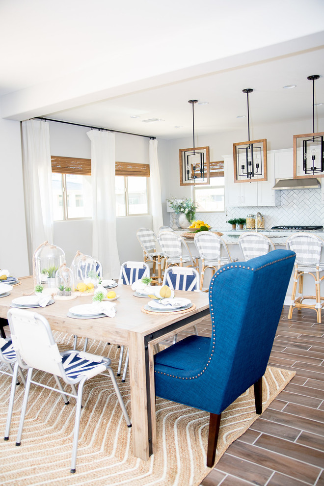 Mid-sized transitional u-shaped ceramic tile and brown floor open concept kitchen photo in Phoenix with a single-bowl sink, shaker cabinets, white cabinets, granite countertops, white backsplash, subway tile backsplash, stainless steel appliances and an island