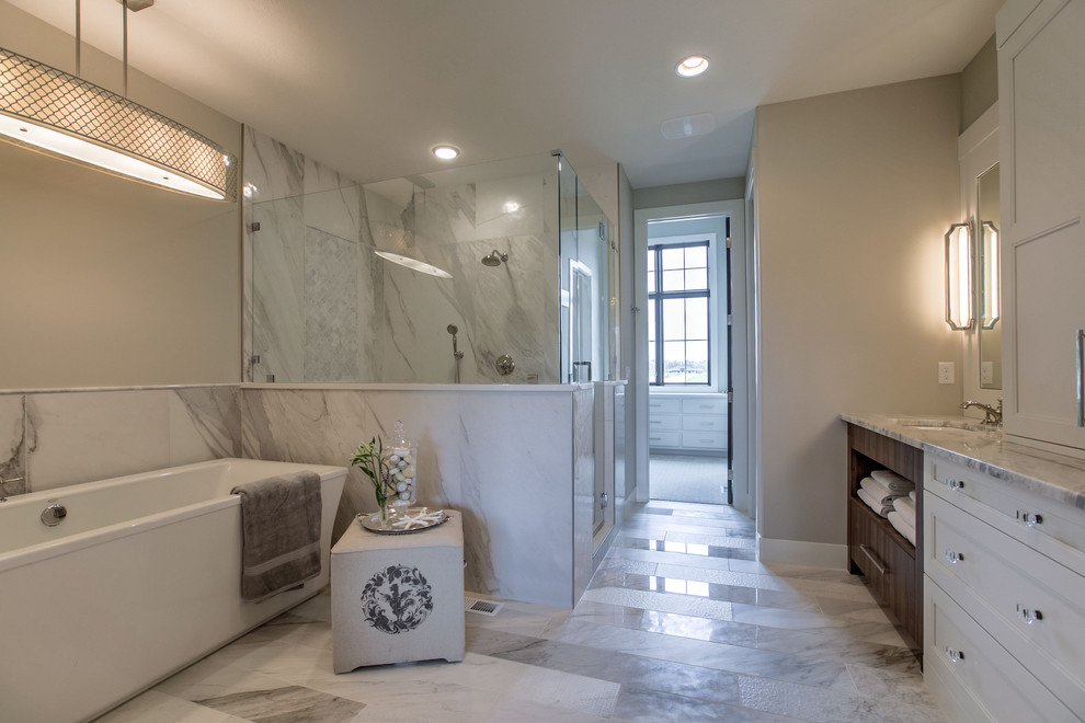 Inspiration for a large country master bathroom in Omaha with shaker cabinets, a freestanding tub, a two-piece toilet, porcelain tile, porcelain floors, an undermount sink, marble benchtops, white cabinets, a corner shower, white tile, beige walls, white floor and a hinged shower door.
