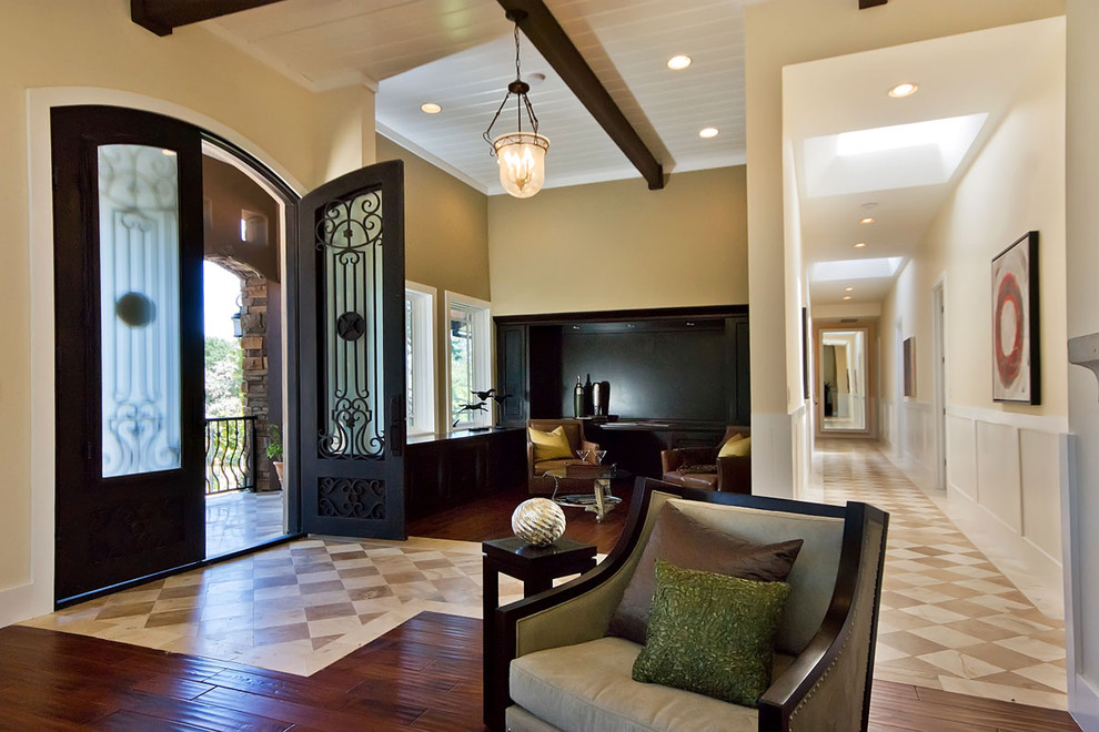 Inspiration for a large contemporary foyer in San Francisco with beige walls and beige floor.