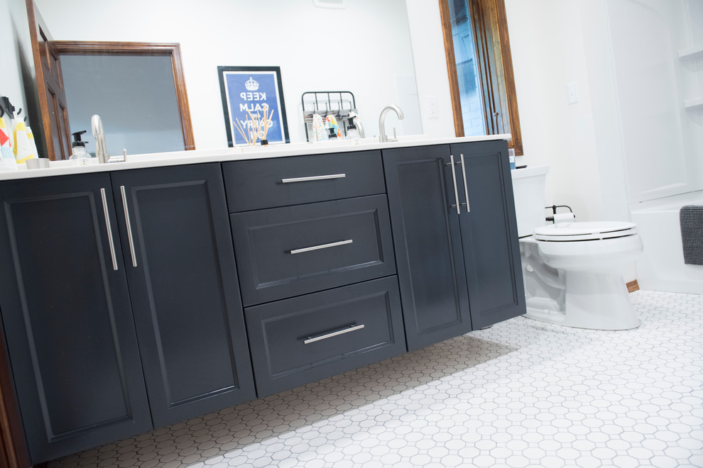 Example of a mid-sized transitional 3/4 white tile and porcelain tile porcelain tile alcove bathtub design with beaded inset cabinets, black cabinets, a two-piece toilet, white walls and quartz countertops
