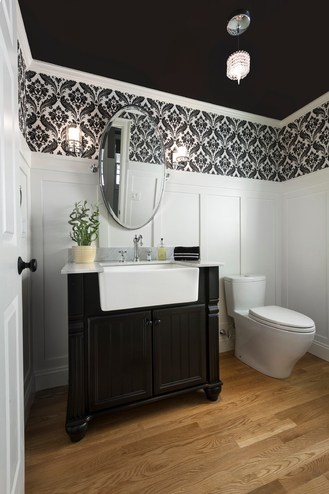 Mid-sized traditional powder room in Boston with furniture-like cabinets, black cabinets, quartzite benchtops, medium hardwood floors and multi-coloured walls.