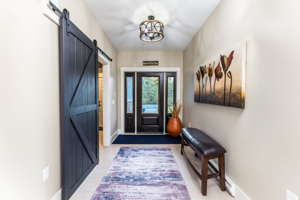 Mid-sized transitional ceramic tile and beige floor entry hall photo with beige walls and a dark wood front door