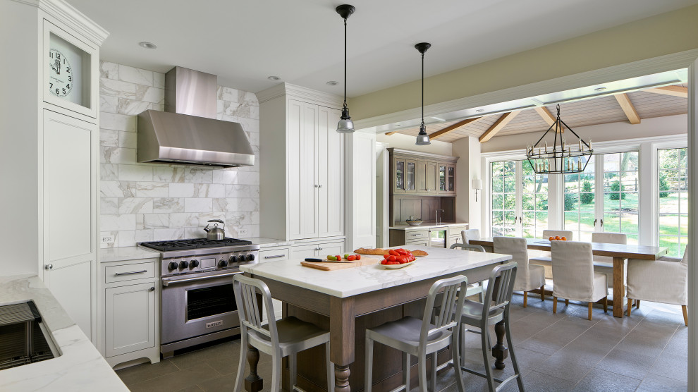 Small u-shaped eat-in kitchen in Philadelphia with an undermount sink, recessed-panel cabinets, marble benchtops, white splashback, marble splashback, stainless steel appliances, porcelain floors, with island, grey floor, white benchtop and exposed beam.
