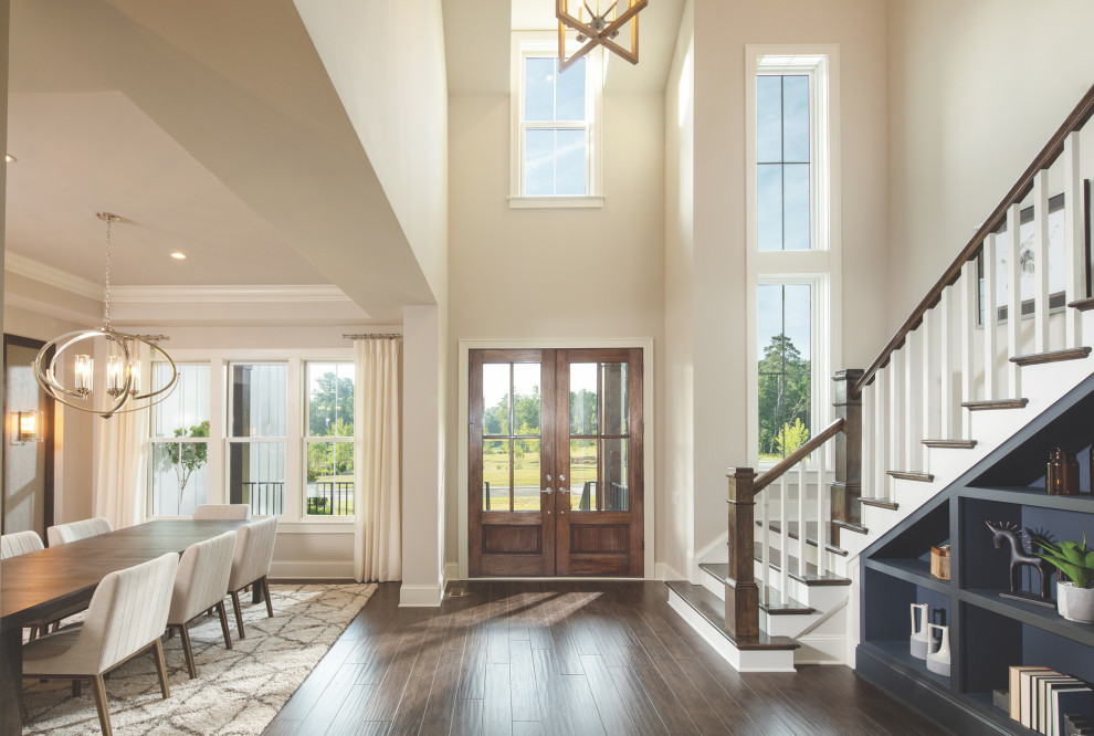 Inspiration for a large country foyer in Nashville with grey walls, dark hardwood floors, a double front door, a medium wood front door, vaulted and panelled walls.
