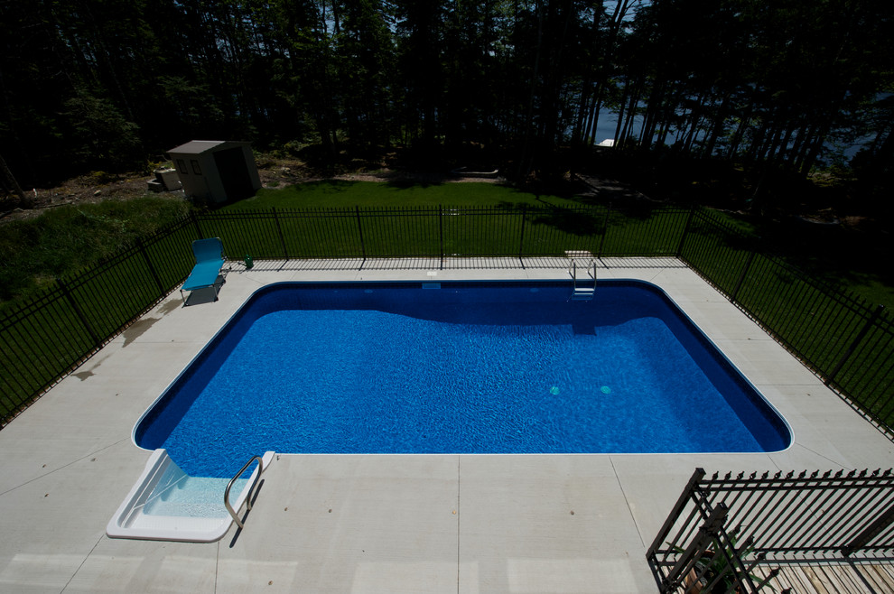 Design ideas for a mid-sized traditional backyard rectangular pool in Other with concrete slab.