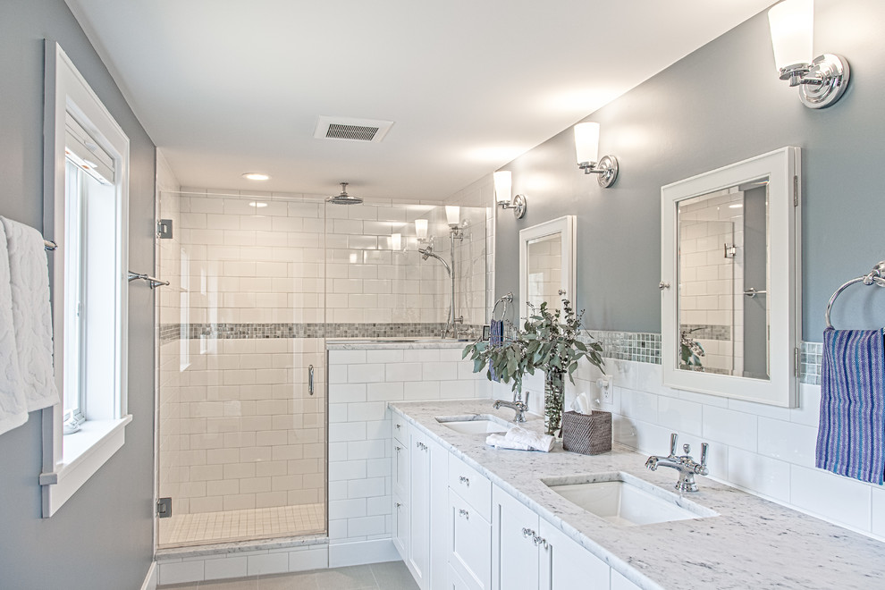 This is an example of a mid-sized arts and crafts master bathroom in Detroit with shaker cabinets, white cabinets, a one-piece toilet, white tile, subway tile, grey walls, ceramic floors, an undermount sink and quartzite benchtops.