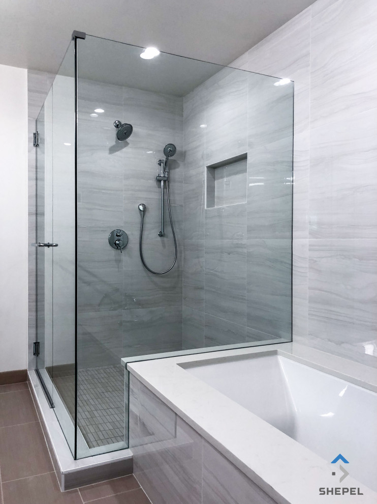 Photo of a medium sized traditional ensuite bathroom in Seattle with a submerged bath, a built-in shower, a one-piece toilet, grey tiles, grey walls, ceramic flooring, a submerged sink, engineered stone worktops, a hinged door, white worktops, double sinks, flat-panel cabinets, dark wood cabinets, brown floors, a wall niche and a built in vanity unit.
