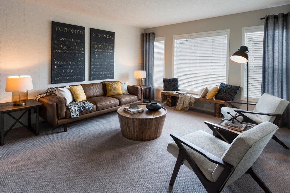 This is an example of a contemporary living room in Calgary with grey walls and carpet.