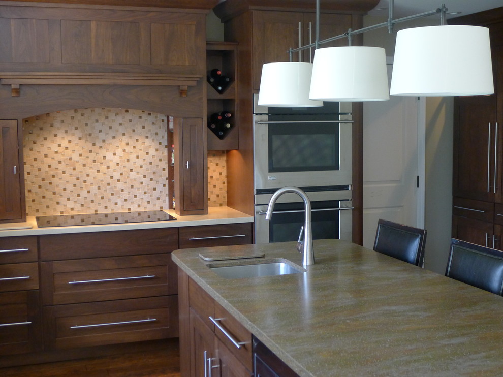 Inspiration for a traditional l-shaped eat-in kitchen in Indianapolis with an undermount sink, medium wood cabinets, solid surface benchtops, beige splashback and stainless steel appliances.