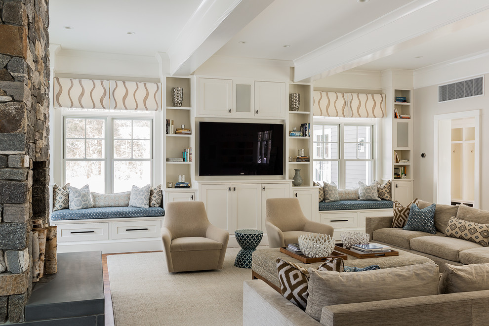 This is an example of a large transitional open concept family room in Boston with a library, a built-in media wall, beige walls, light hardwood floors, no fireplace and beige floor.