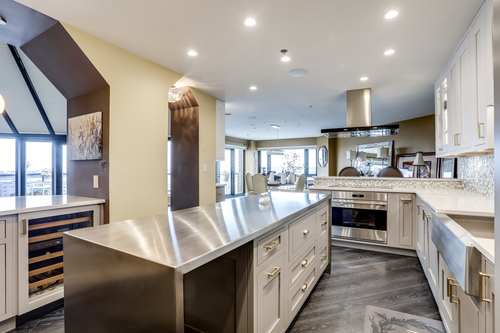 Example of a large transitional enclosed kitchen design in Baltimore with a farmhouse sink, mosaic tile backsplash, stainless steel appliances and an island