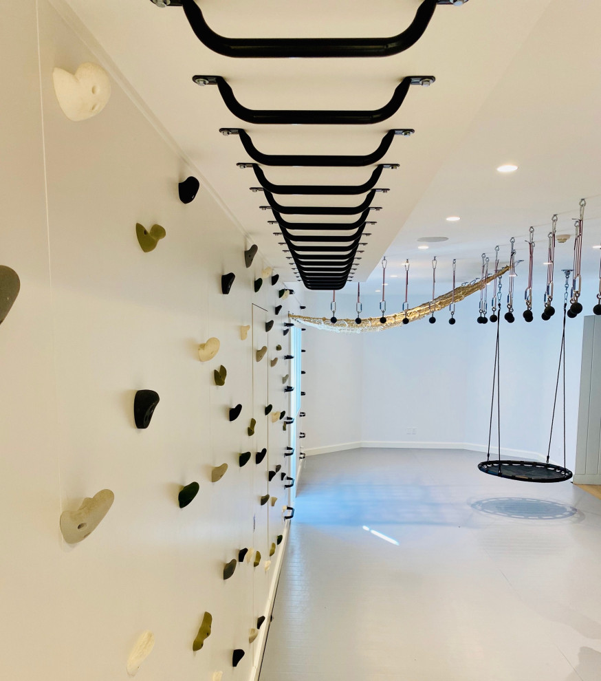 Minimalist perfection! - Mid-sized country gender-neutral light wood floor, gray floor, wood ceiling and wall paneling playroom photo in New York with white walls
