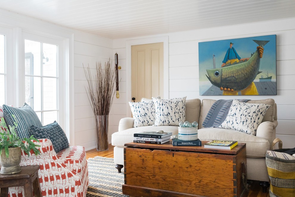 This is an example of a beach style living room in Boston with white walls.