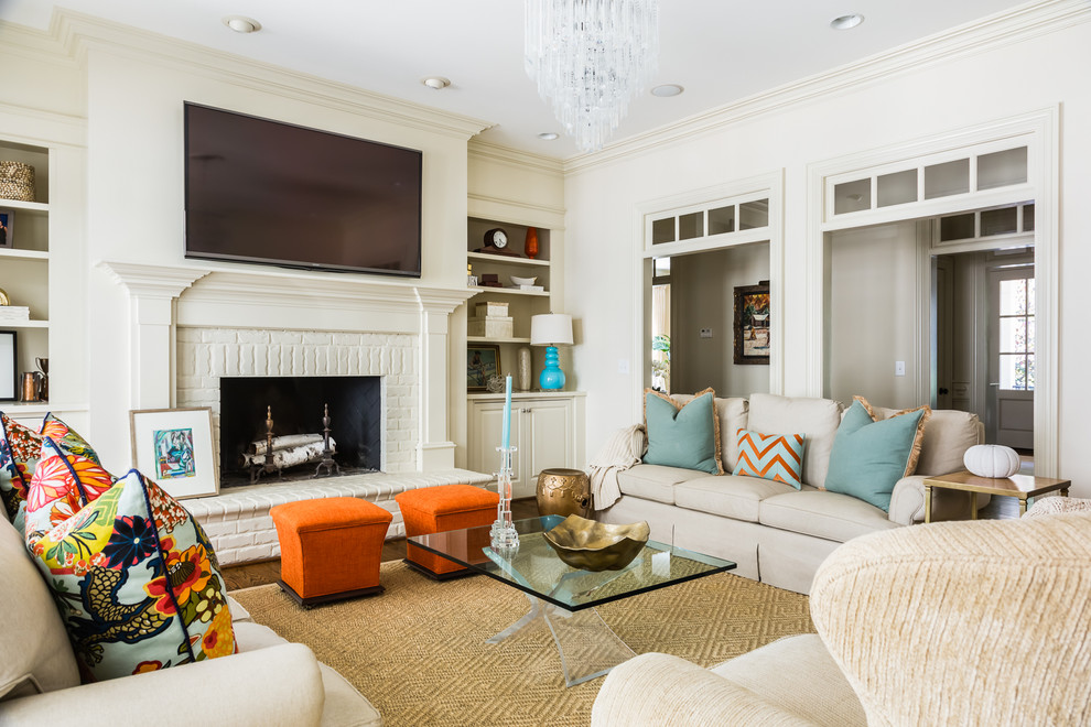 Inspiration for a transitional formal living room in Raleigh with white walls, dark hardwood floors, a standard fireplace, a brick fireplace surround and a wall-mounted tv.