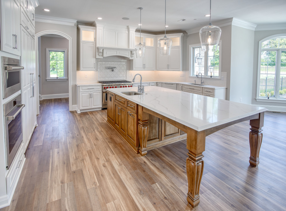 Transitional Kitchen with Two Toned Gathering Island & Archways