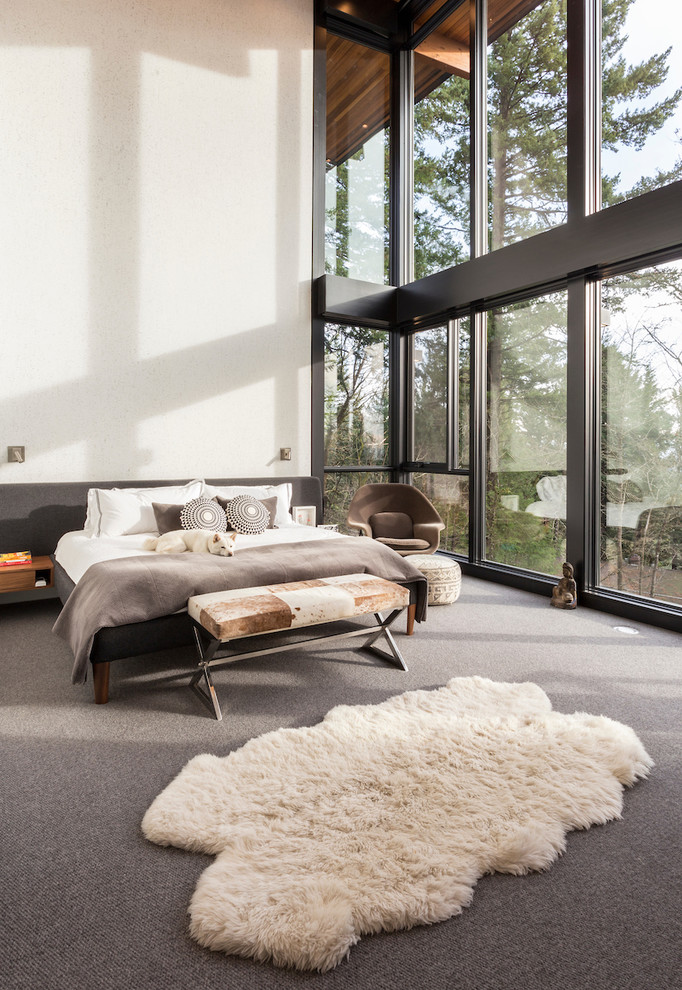 Photo of a large midcentury master bedroom in Portland with white walls, carpet, a standard fireplace, a metal fireplace surround and grey floor.