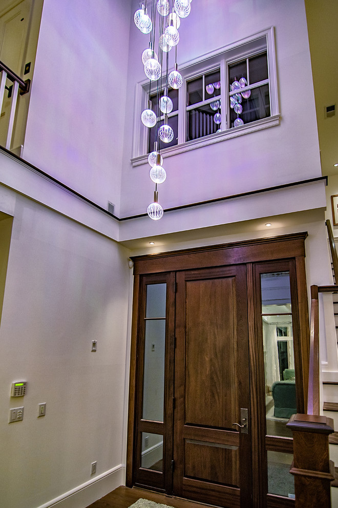 Design ideas for a mid-sized traditional front door in Atlanta with white walls, medium hardwood floors, a single front door, a dark wood front door and brown floor.