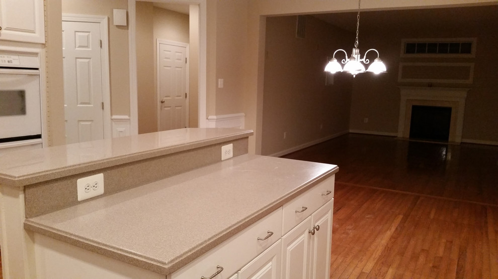 Kitchen - kitchen idea in Wilmington with white cabinets, white appliances and an island