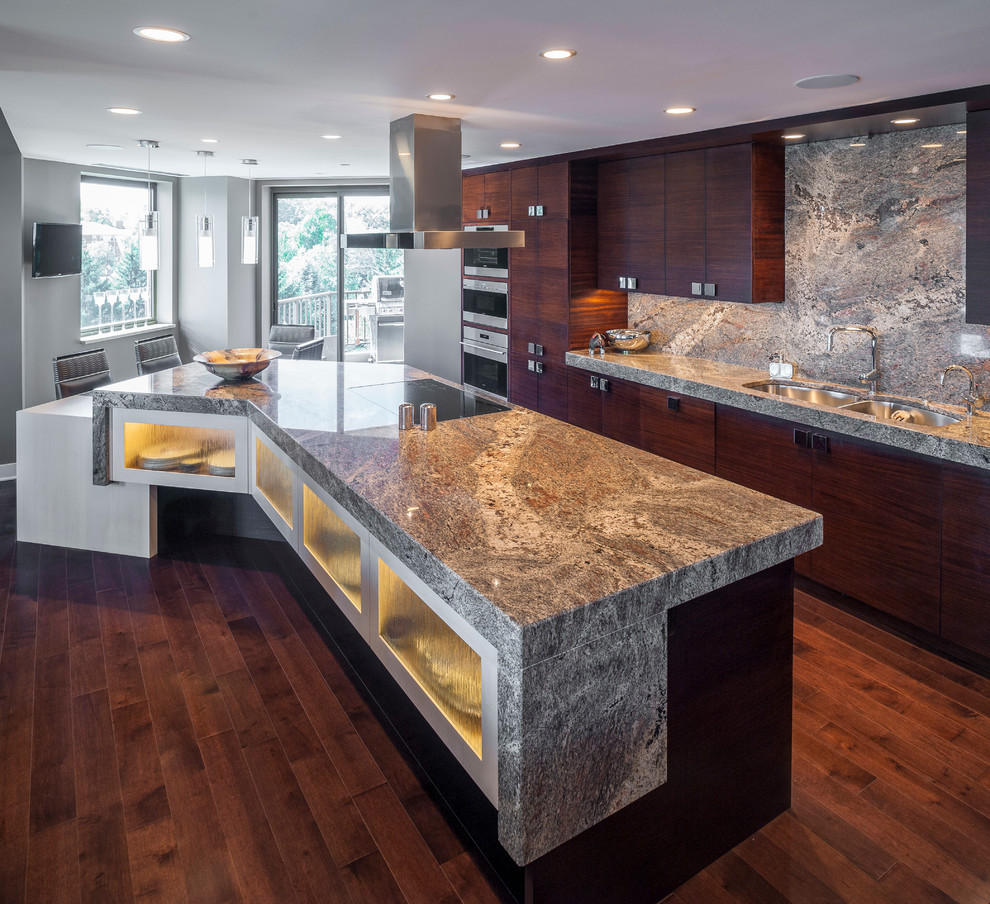 Large contemporary l-shaped kitchen pantry in Cincinnati with a double-bowl sink, flat-panel cabinets, dark wood cabinets, granite benchtops, multi-coloured splashback, stone slab splashback, stainless steel appliances, dark hardwood floors, with island and brown floor.