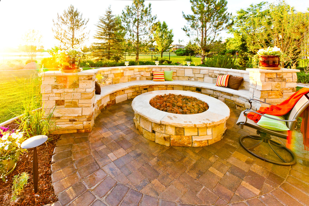 This is an example of a large contemporary backyard patio in Denver with a fire feature and concrete pavers.