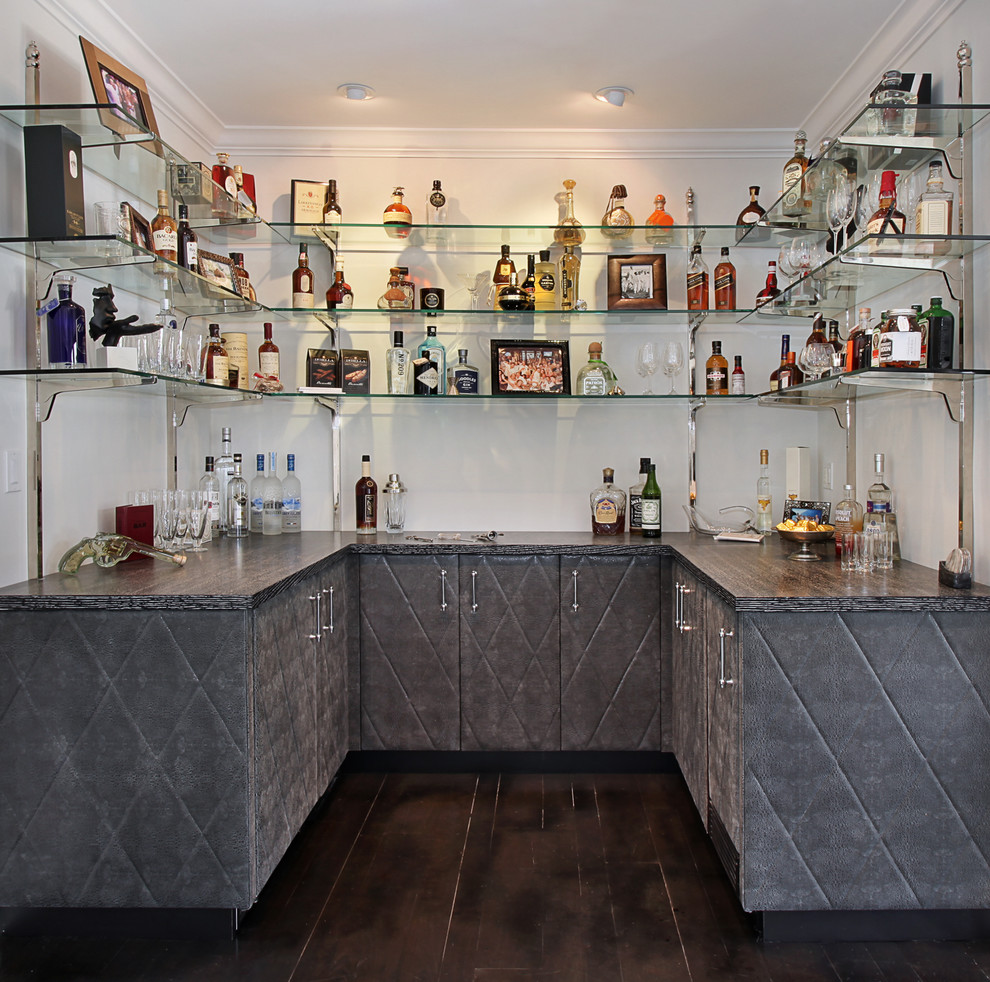 This is an example of a small transitional u-shaped wet bar in Los Angeles with dark hardwood floors, no sink, grey cabinets and brown floor.