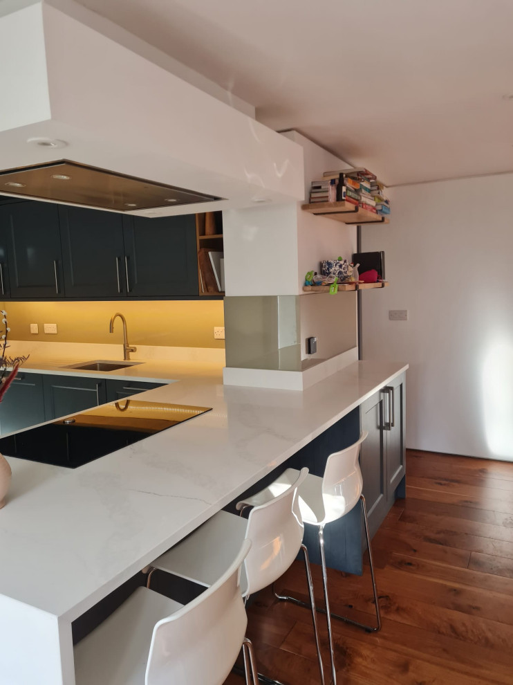 Inspiration for a medium sized contemporary grey and white u-shaped open plan kitchen in Edinburgh with a submerged sink, shaker cabinets, grey cabinets, quartz worktops, engineered quartz splashback, black appliances, ceramic flooring, multi-coloured floors, white worktops, a drop ceiling and feature lighting.