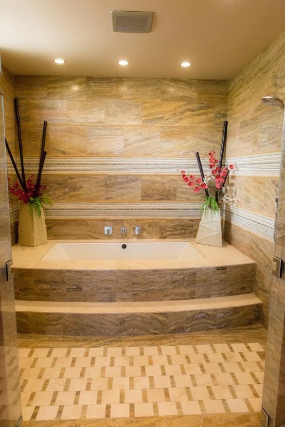 Inspiration for a large transitional master wet room bathroom in Hawaii with an alcove tub, beige tile, brown tile, porcelain tile, brown walls, porcelain floors, multi-coloured floor and a hinged shower door.