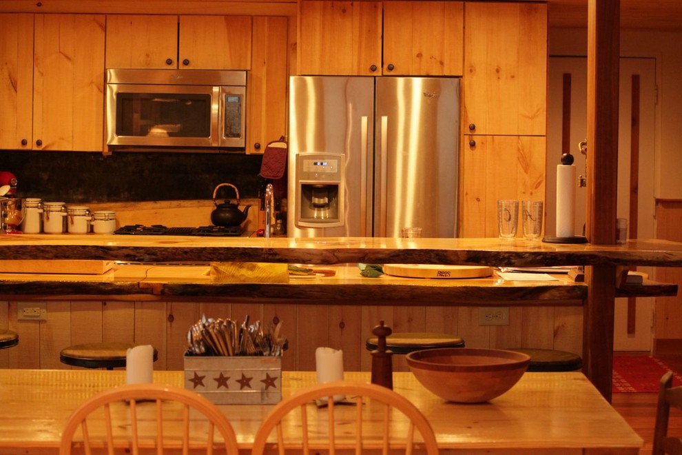 Mid-sized mountain style u-shaped medium tone wood floor eat-in kitchen photo in Burlington with an undermount sink, flat-panel cabinets, light wood cabinets, wood countertops, metallic backsplash, metal backsplash, stainless steel appliances and a peninsula