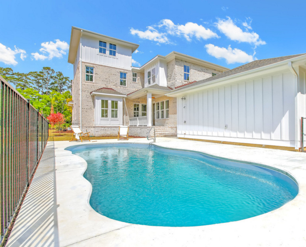 Mid-sized transitional backyard custom-shaped and concrete pool photo