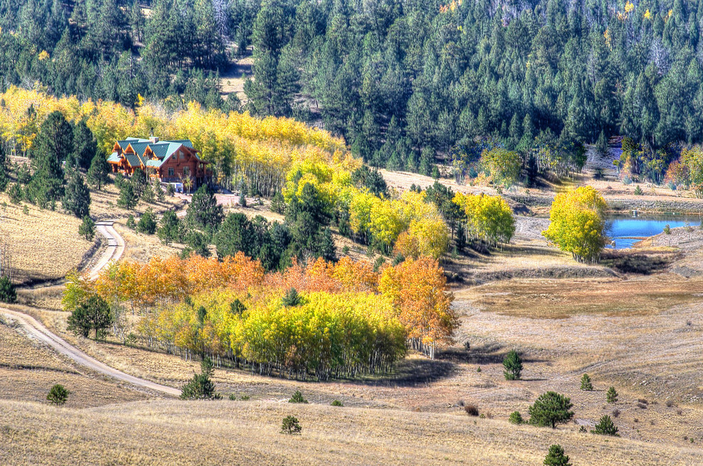 Inspiration for a large rustic brown two-story wood gable roof remodel in Denver with a metal roof