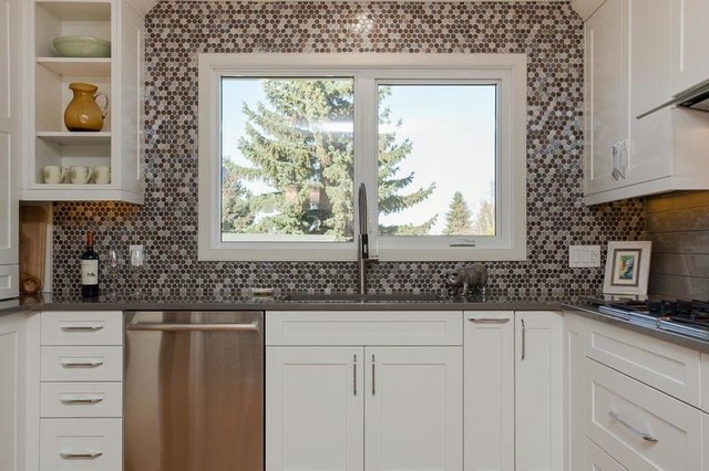 Transitional u-shaped enclosed kitchen photo in Edmonton with an undermount sink, shaker cabinets, white cabinets, concrete countertops, multicolored backsplash, mosaic tile backsplash, stainless steel appliances and no island