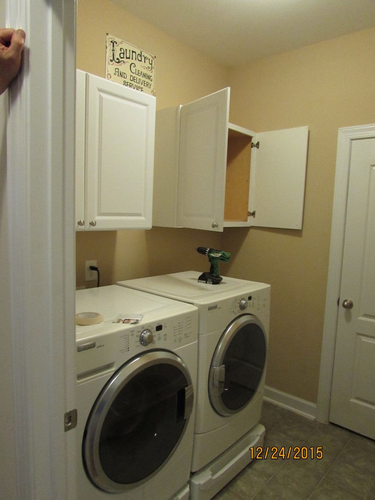 Design ideas for a small transitional laundry room in Raleigh.